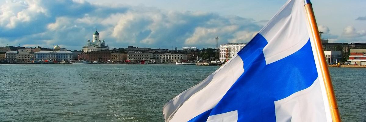 Helsinki from the sea, a Finnish flag on the forefront of the image.