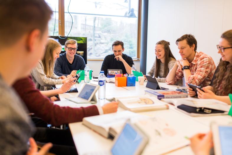 Student working together around a table.
