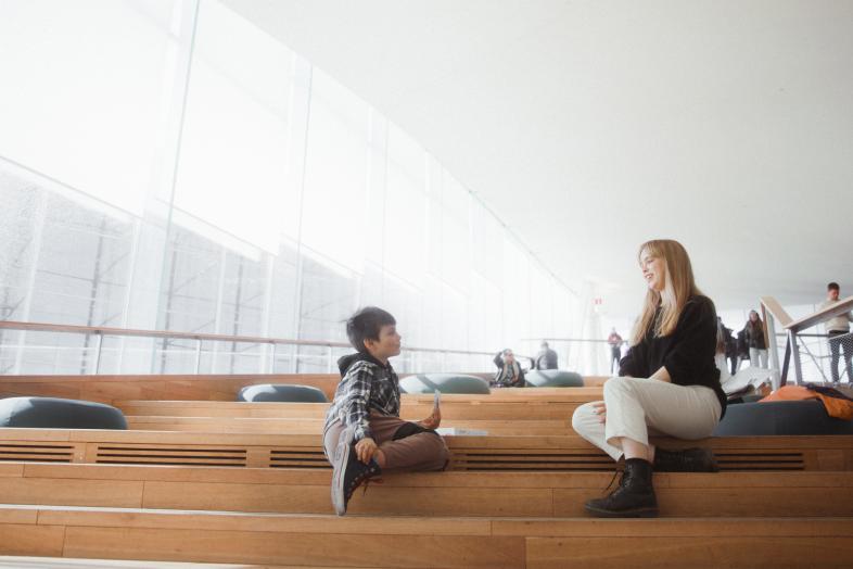 Student with child in the library.