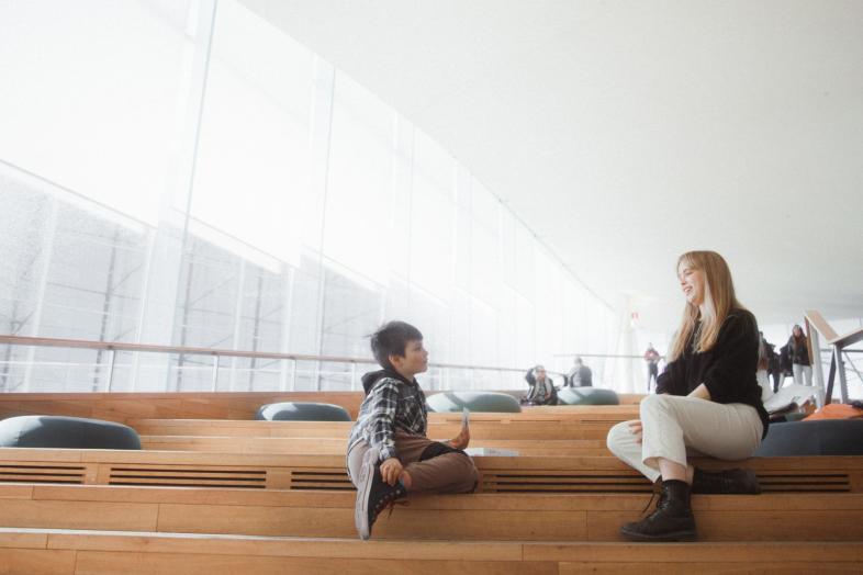 Child and student in the library.