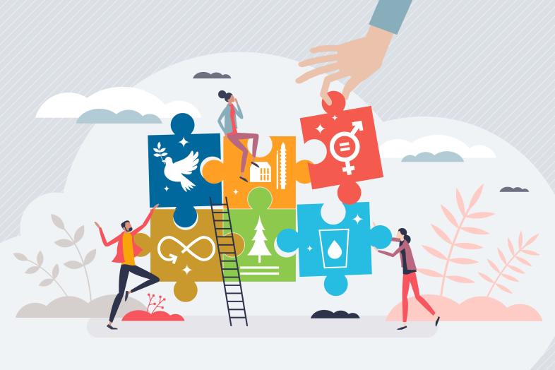 Människor bygger ett pussel med färgglada bitar som symboliserar målen för hållbar utveckling.