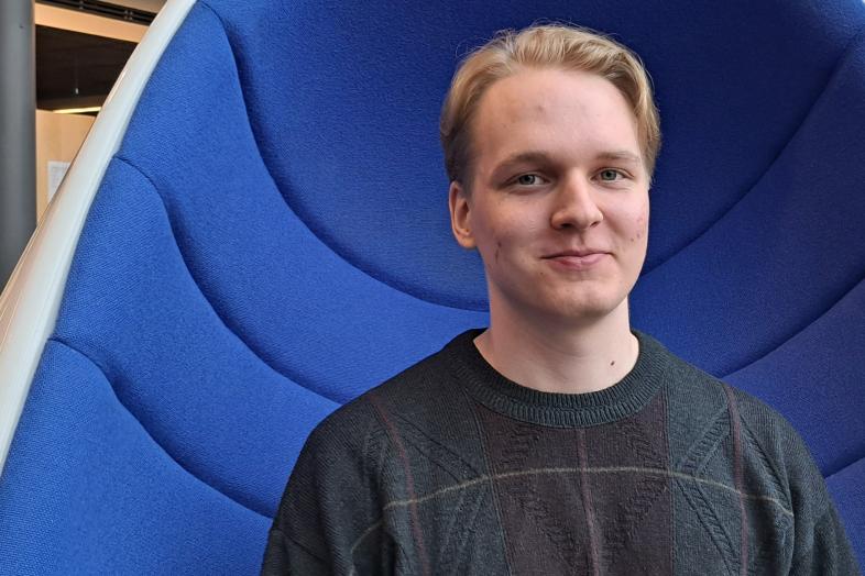 Mikko Seppälä sitting in a blue chair.
