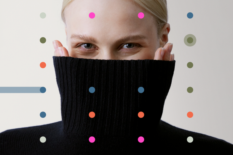 A person wearing a black turtleneck sweater, colourful dots on the foreground.