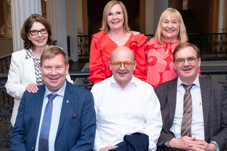 The University's leadership smiling happily.