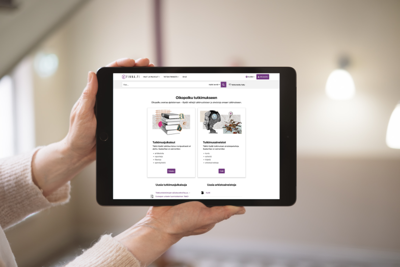 Hands are holding a tablet displaying the Finna Oikopolku service on the screen.