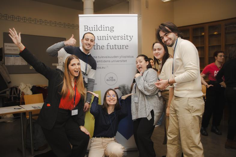students in front of rollup