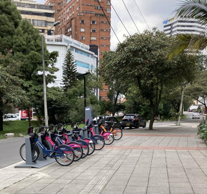 City bikes, buildings, trees.