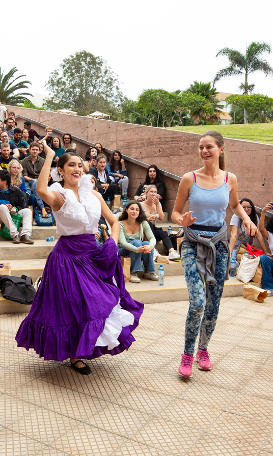 Danving students on campus palm tree on the background.