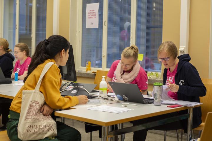 Opiskelija ja opintoneuvojia pöydän ääressä.
